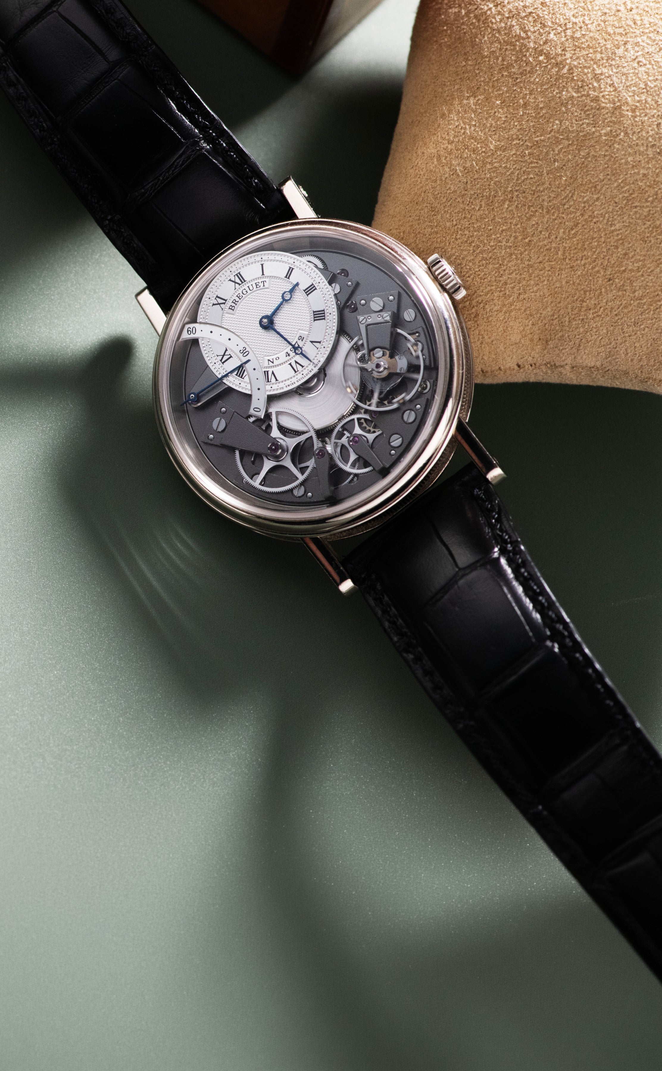Breguet Tradition Automatique Seconde Rétrograde 7097 in white gold, featuring an exposed anthracite movement, off-centre silver guilloché dial, blued hands, retrograde seconds display and black alligator strap.